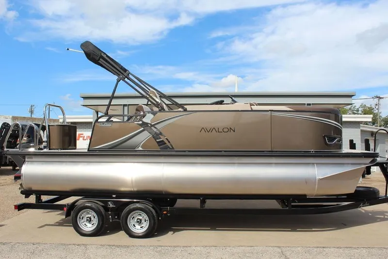 Slide: The Image of 2026 Avalon LSZ Cruise Rear Bench 21 pontoon boat on trailer, side view. - 7