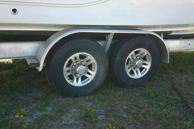Slide: The Image of Trailer wheels of a 2021 Sea Fox 288 Commander boat on grass. - 18