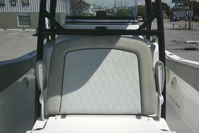 Slide: The Image of 2021 Sea Fox 288 Commander boat seat with hexagonal pattern in a parking lot. - 24