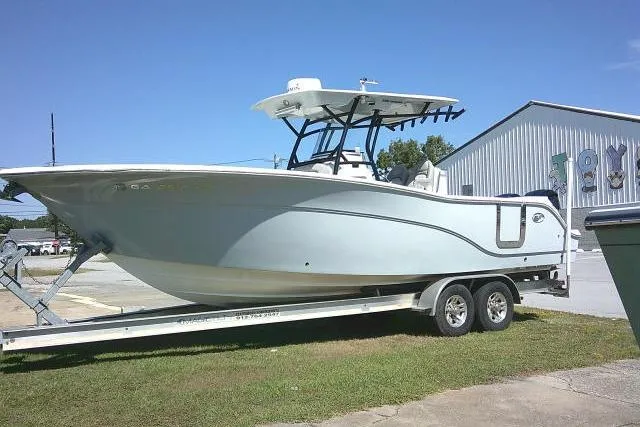 Slide: The Image of 2021 Sea Fox 288 Commander boat on trailer, parked outdoors near a building. - 5
