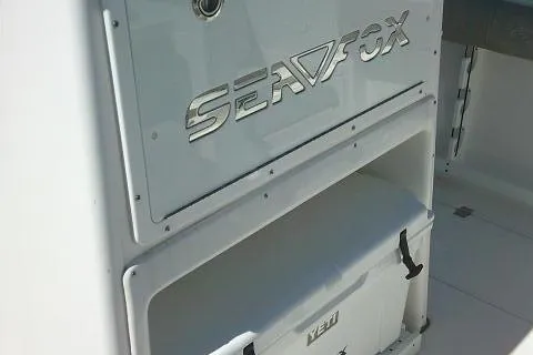 Slide: The Image of 2021 Sea Fox 288 Commander boat interior with storage compartment and Yeti cooler. - 50