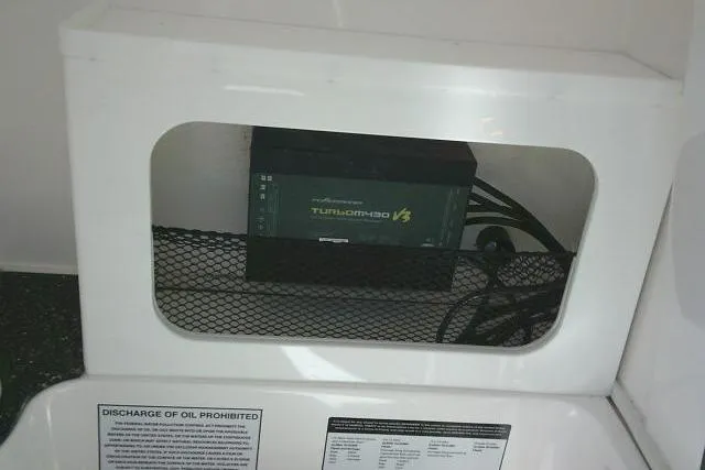 Slide: The Image of 2021 Sea Fox 288 Commander boat compartment with Turbo MFD V3 device and safety instructions. - 65