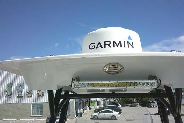 Slide: The Image of 2021 Sea Fox 288 Commander with Garmin radar, parked in a lot under clear blue sky. - 72