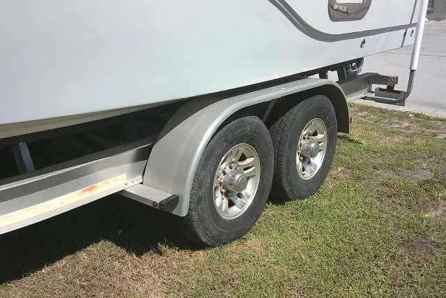 Slide: The Image of Trailer wheels of a 2021 Sea Fox 288 Commander boat on grass. - 8