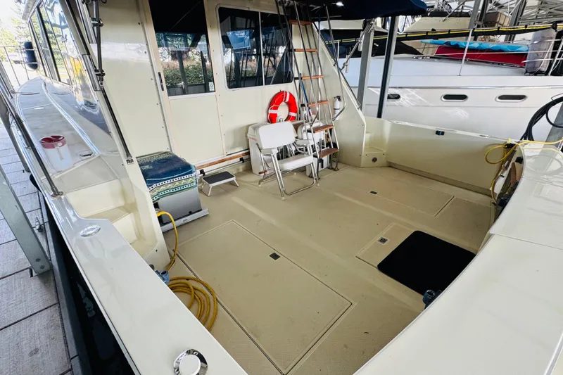 Slide: The Image of 1987 Tollycraft 40 Sport Sedan boat deck with seating and life preserver. - 11