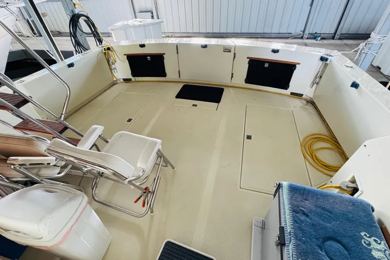 Slide: The Image of 1987 Tollycraft 40 Sport Sedan boat deck with chairs and storage compartments. - 14