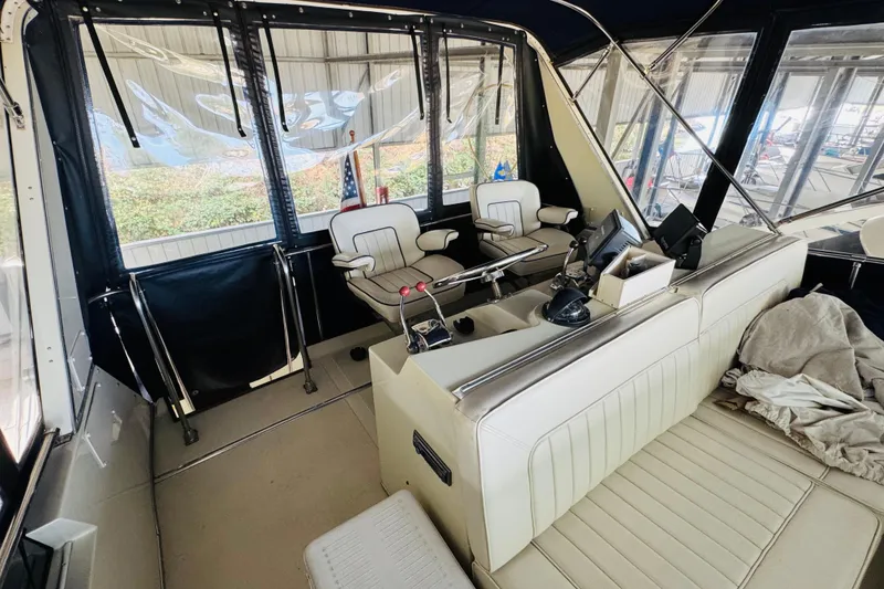 Slide: The Image of 1987 Tollycraft 40 Sport Sedan interior with helm, seating, and navigation equipment. - 19