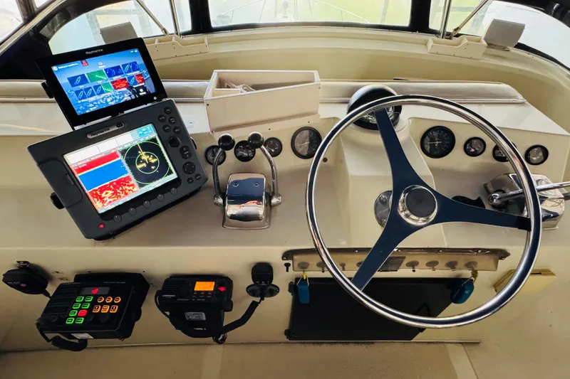 Slide: The Image of 1987 Tollycraft 40 Sport Sedan helm with navigation equipment and steering wheel. - 21