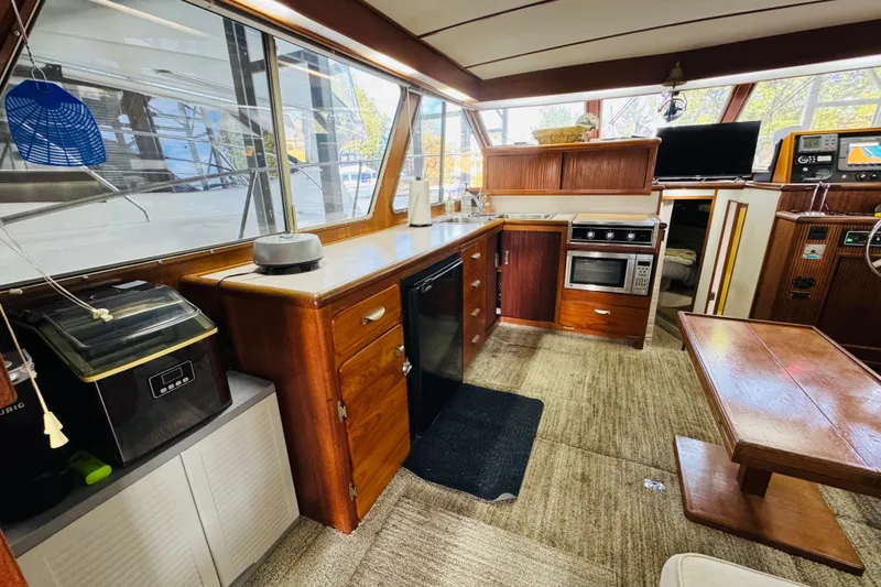 Slide: The Image of Interior of 1987 Tollycraft 40 Sport Sedan with kitchen and dining area. - 29