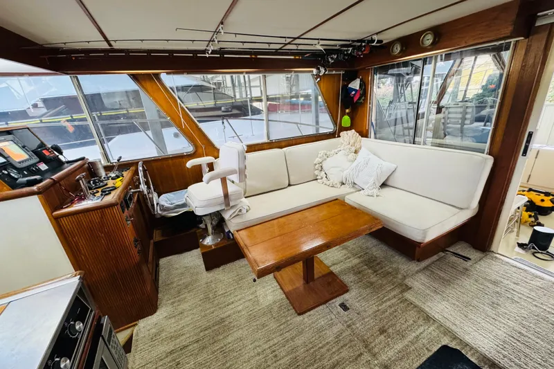 Slide: The Image of 1987 Tollycraft 40 Sport Sedan interior with helm, seating, and wooden accents. - 33