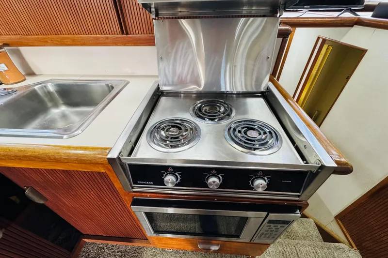 Slide: The Image of 1987 Tollycraft 40 Sport Sedan kitchen with stove, oven, and sink. - 36