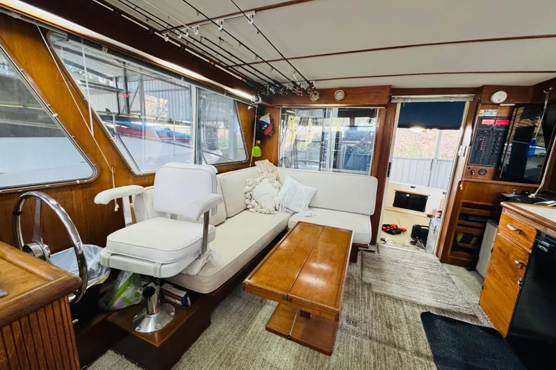 Slide: The Image of Interior of 1987 Tollycraft 40 Sport Sedan with cozy seating and wooden accents. - 39