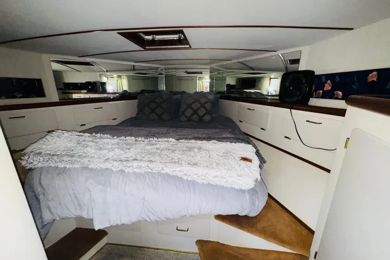 Slide: The Image of 1987 Tollycraft 40 Sport Sedan cabin interior with cozy bed and storage drawers. - 41