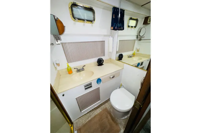 Slide: The Image of Bathroom interior of 1987 Tollycraft 40 Sport Sedan with sink, mirror, and toilet. - 44