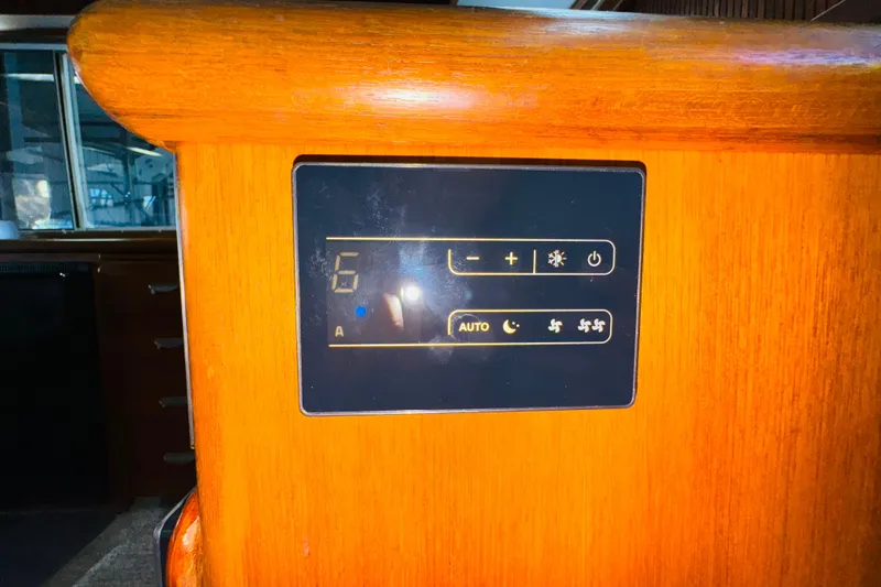 Slide: The Image of Control panel on 1987 Tollycraft 40 Sport Sedan boat, featuring temperature and fan settings. - 48