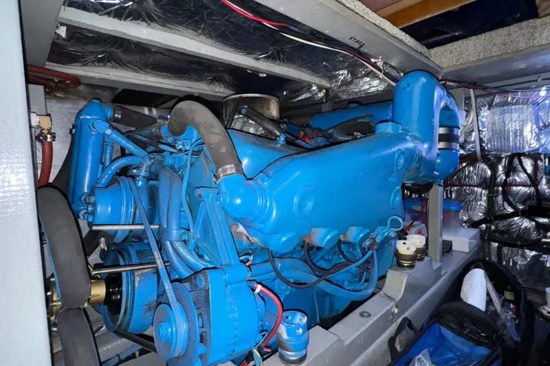 Slide: The Image of Engine room of 1987 Tollycraft 40 Sport Sedan with blue marine engine. - 53