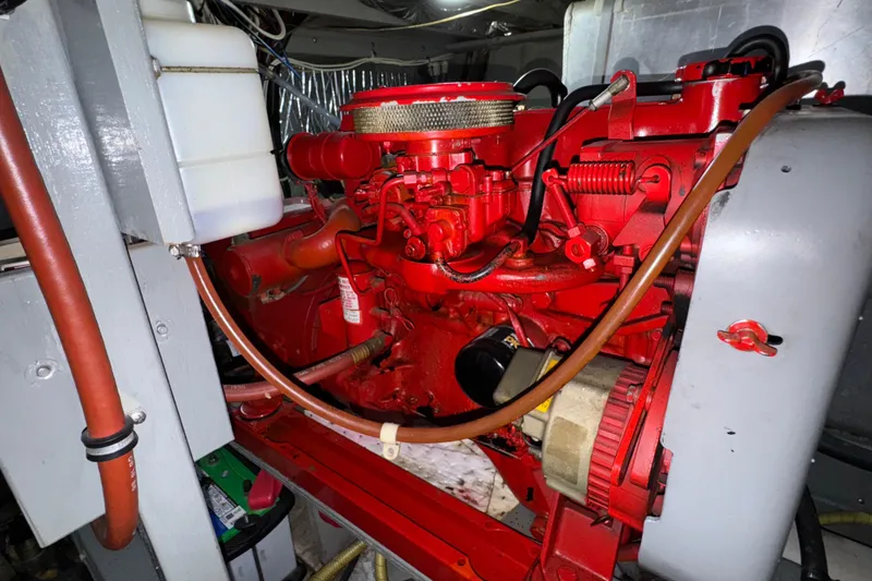 Slide: The Image of Engine compartment of a 1987 Tollycraft 40 Sport Sedan, featuring a red engine. - 59
