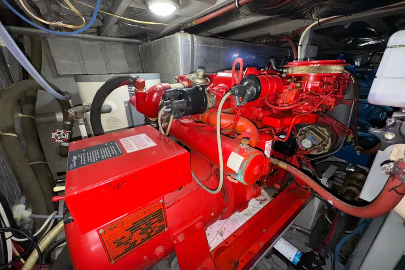 Slide: The Image of Engine room of 1987 Tollycraft 40 Sport Sedan with red machinery and wiring. - 60