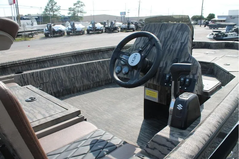 Slide: The Image of 2026 Excel Bolt 203 boat interior with camo design and steering wheel. - 11