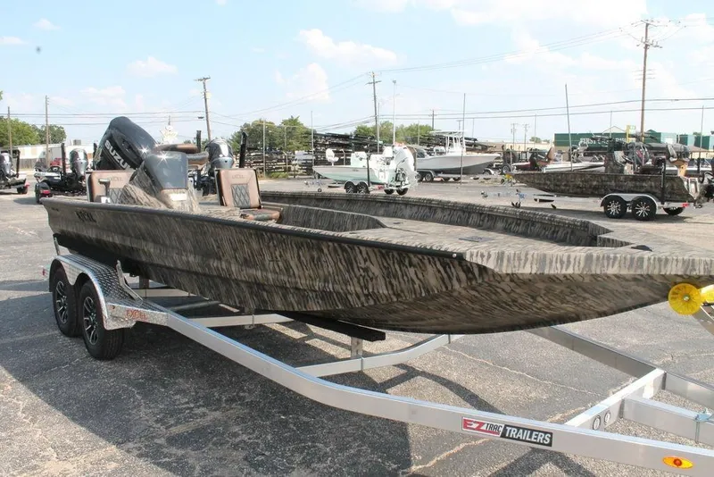 Slide: The Image of 2026 Excel Bolt 203 boat on trailer, camo design, parked in a lot. - 5