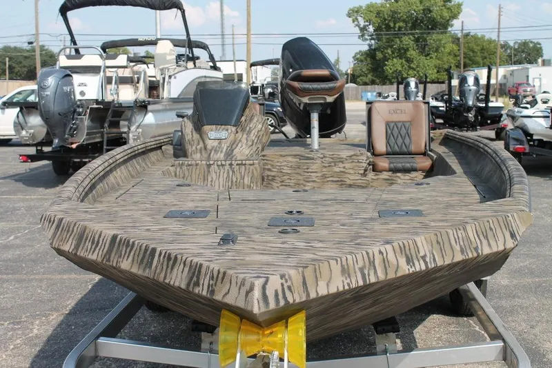 Slide: The Image of 2026 Excel Bolt 203 boat with camouflage design on a trailer in a parking lot. - 7