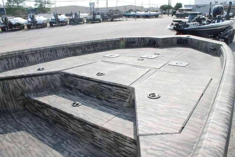 Slide: The Image of 2026 Excel Bolt 203 boat deck with camo pattern, featuring multiple storage compartments. - 9