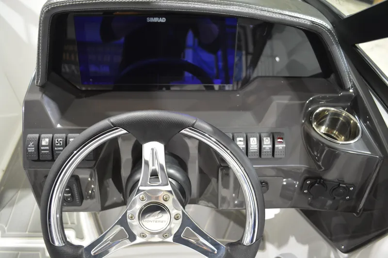 Slide: The Image of Steering console of 2026 Monterey M-45 boat with Simrad display and control buttons. - 12