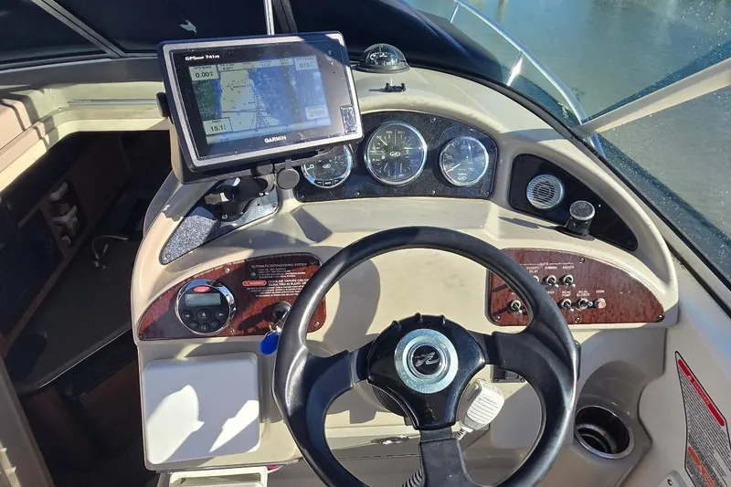 Slide: The Image of Dashboard of a 2006 Sea Ray 260 Sundancer boat with navigation equipment. - 3
