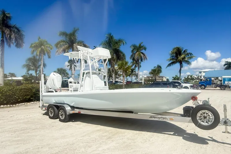The Image of 2026 Yellowfin 24 Bay CE boat cruising on calm waters under clear blue sky. - 0