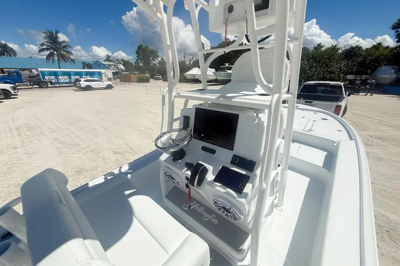Slide: The Image of 2026 Yellowfin 24 Bay CE boat cruising on a sunny day near the shoreline. - 1