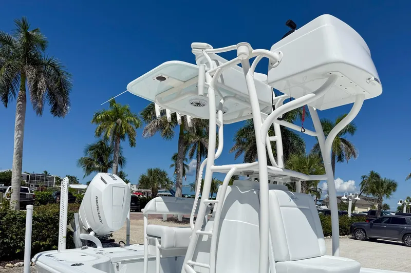 Slide: The Image of 2026 Yellowfin 24 Bay CE boat with tower, set against a tropical backdrop. - 13