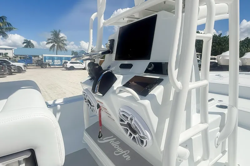 Slide: The Image of 2026 Yellowfin 24 Bay CE boat dashboard with steering wheel and electronic displays. - 3