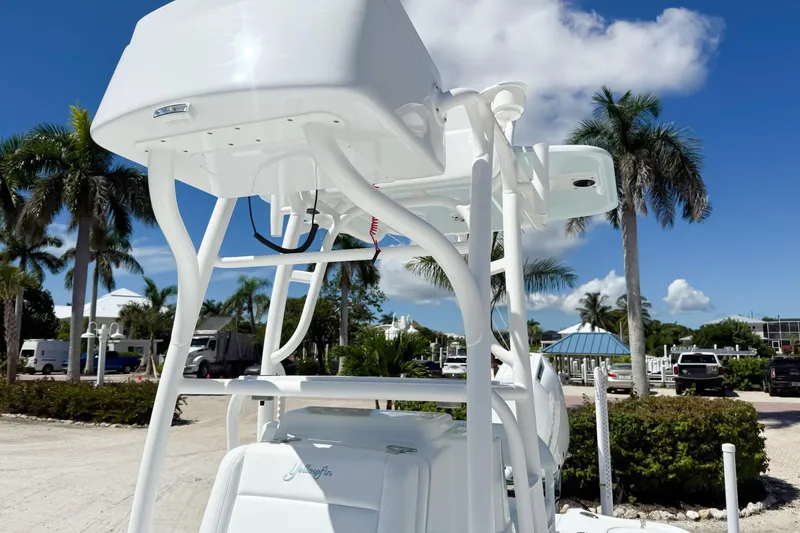 Slide: The Image of 2026 Yellowfin 24 Bay CE boat console with steering wheel and electronics, parked outdoors. - 4