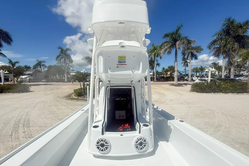 Slide: The Image of 2026 Yellowfin 24 Bay CE boat with tower, parked under clear blue sky. - 8