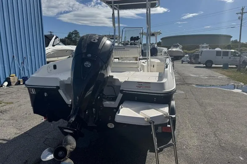 Slide: The Image of 2018 Bayliner Element F21 boat with outboard motor in a marina setting. - 4