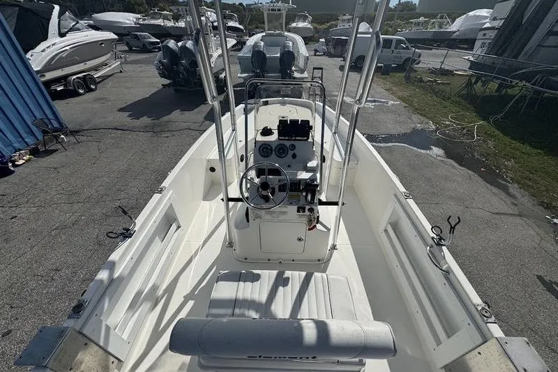 Slide: The Image of 2018 Bayliner Element F21 boat interior with steering console, parked in a marina. - 7
