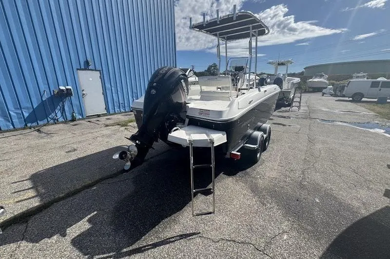 Slide: The Image of 2018 Bayliner Element F21 boat with outboard motor and trailer, parked outdoors. - 9