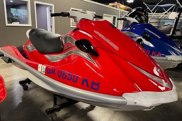The Image of 2005 Yamaha WaveRunner VX 110 in red, displayed indoors on a stand. - 1