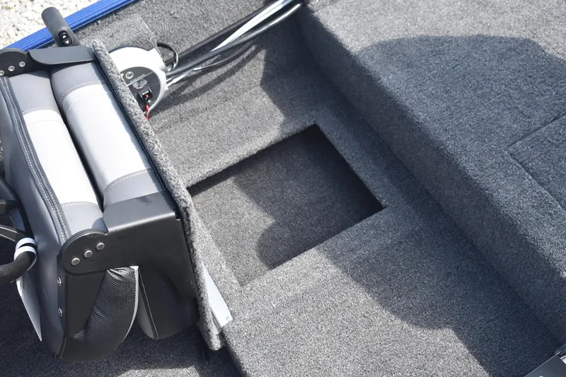 Slide: The Image of 2026 Lowe Skorpion 17 boat interior with seat and open storage compartment. - 10
