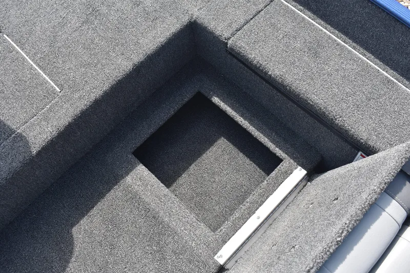 Slide: The Image of Interior view of 2026 Lowe Skorpion 17 boat's storage compartment with carpeted finish. - 12