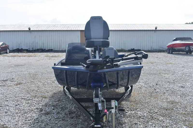 Slide: The Image of 2026 Lowe Skorpion 17 boat on trailer, parked outdoors, featuring sleek design and modern seating. - 3