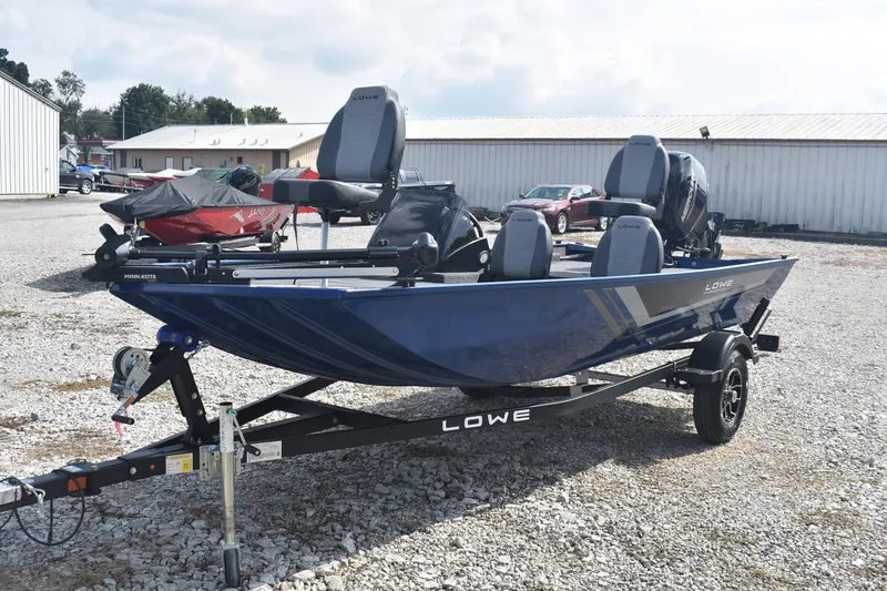 Slide: The Image of 2026 Lowe Skorpion 17 fishing boat on trailer, parked outdoors. - 4