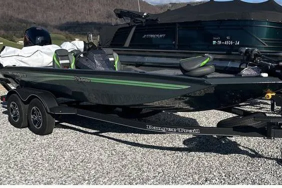 Slide: The Image of 2025 Ranger RT198P Fishing Package on trailer, parked on gravel, with scenic mountain backdrop. - 3