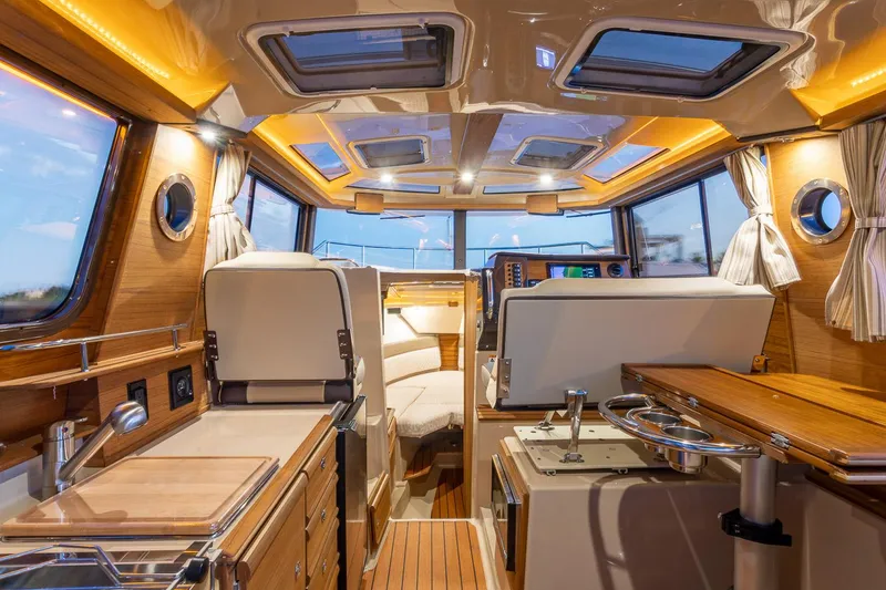 Slide: The Image of Manufacturer Provided Image: Interior of 2025 Ranger Tugs R-27 boat, featuring modern design and wood finishes. - 16