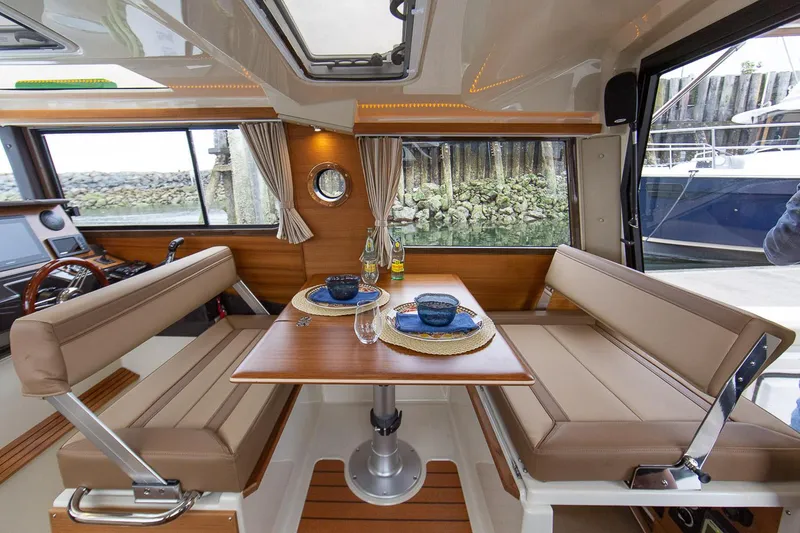 Slide: The Image of Manufacturer Provided Image: 2025 Ranger Tugs R-27 interior dining area with table and seating. - 18