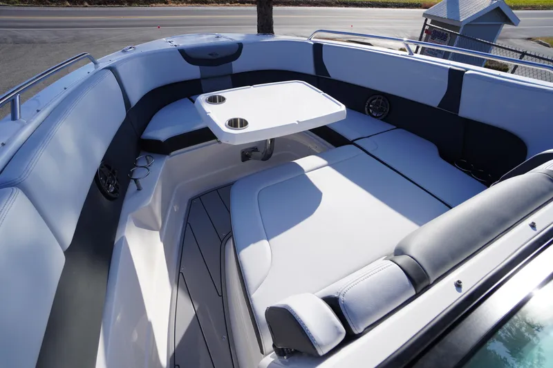 Slide: The Image of 2026 Chaparral 280 OSX boat interior with cushioned seating and table. - 11