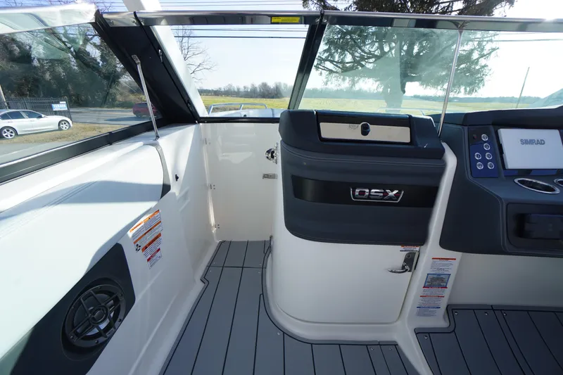 Slide: The Image of 2026 Chaparral 280 OSX boat interior with modern dashboard and sleek design. - 13