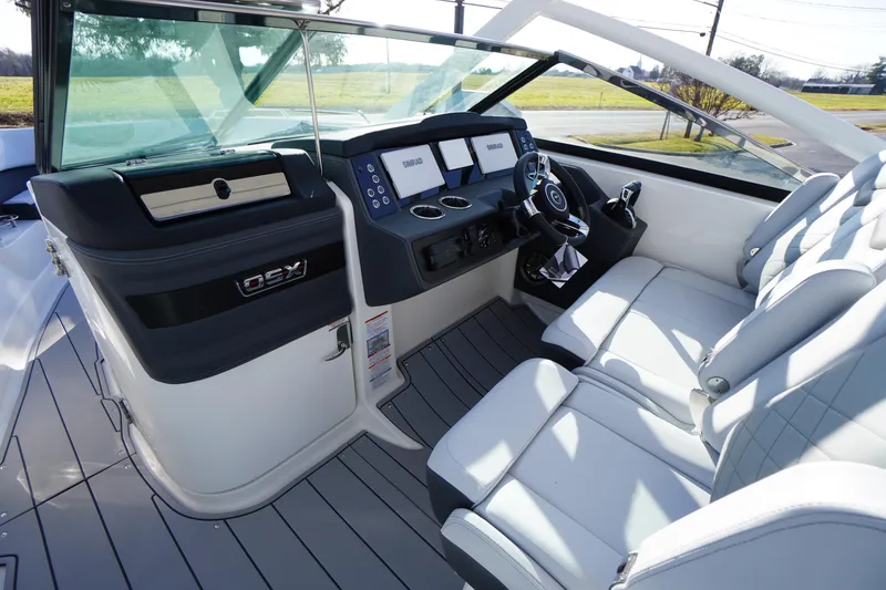 Slide: The Image of 2026 Chaparral 280 OSX boat interior with modern dashboard and luxurious seating. - 14