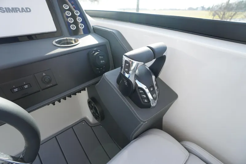 Slide: The Image of Control panel of 2026 Chaparral 280 OSX boat with modern throttle and display. - 16