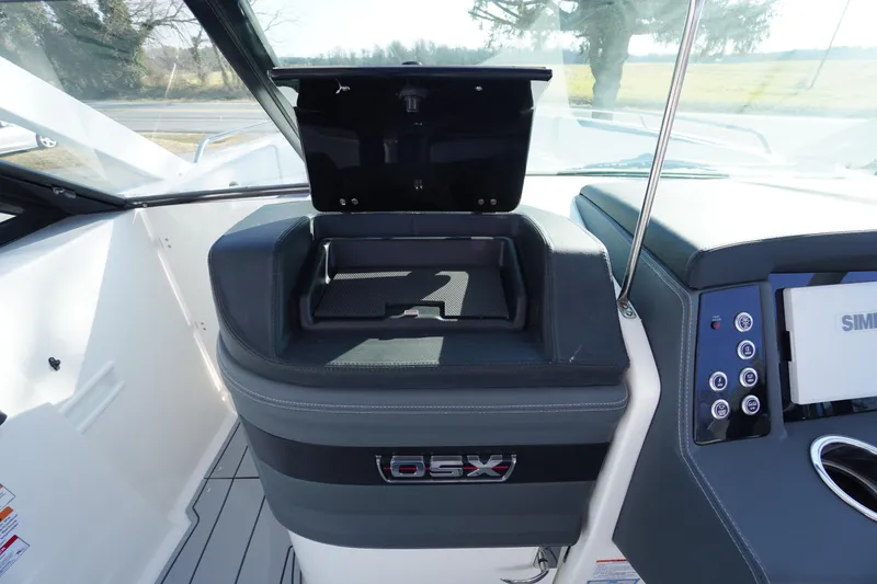 Slide: The Image of 2026 Chaparral 280 OSX boat dashboard with storage compartment and control panel. - 19